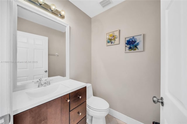 bathroom with vanity, toilet, and tile patterned flooring