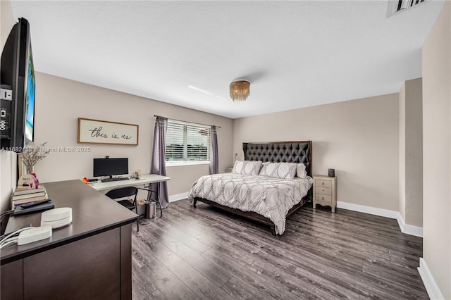 bedroom with dark hardwood / wood-style floors