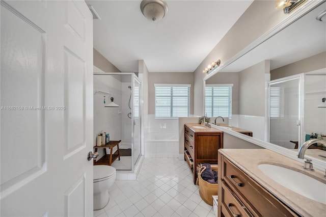 bathroom featuring vanity, a shower with shower door, tile patterned floors, and toilet