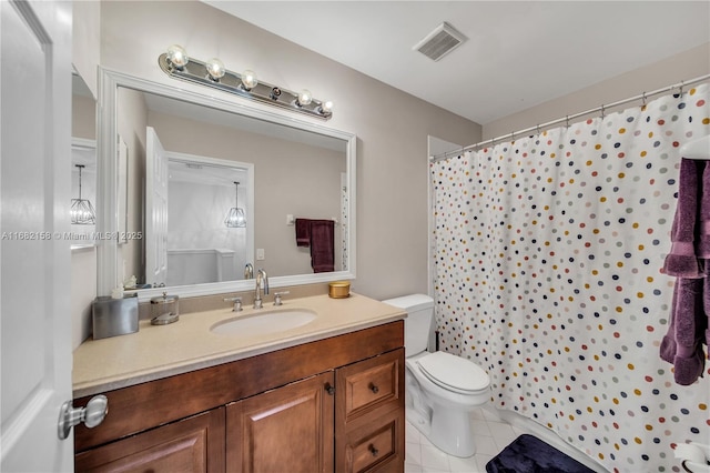 bathroom featuring tile patterned floors, toilet, and vanity