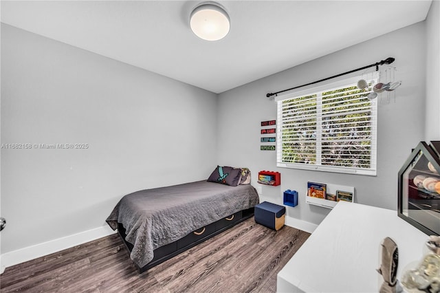 bedroom with dark hardwood / wood-style flooring