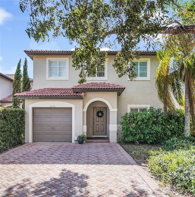 mediterranean / spanish-style home with a garage