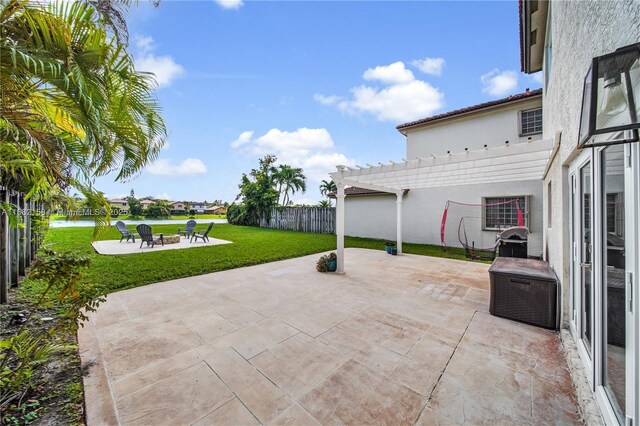 view of yard with a water view, a patio area, and an outdoor fire pit