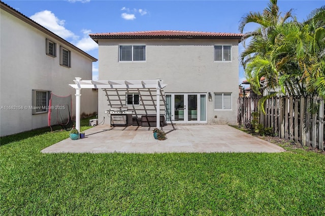 rear view of house featuring french doors, a lawn, a patio area, and a pergola