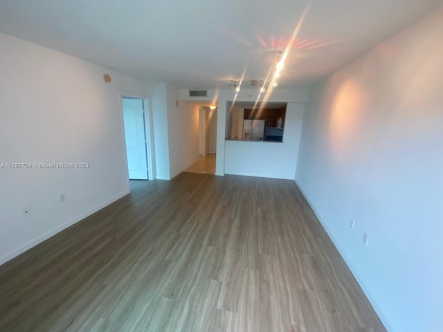 unfurnished living room with dark hardwood / wood-style flooring