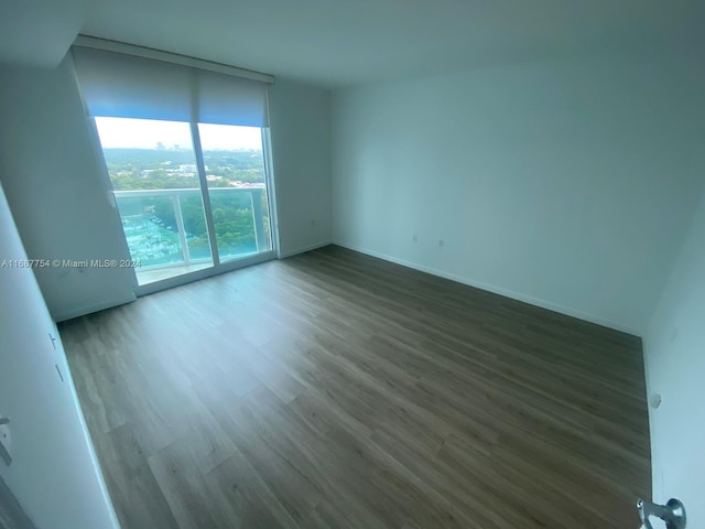 empty room featuring dark hardwood / wood-style flooring