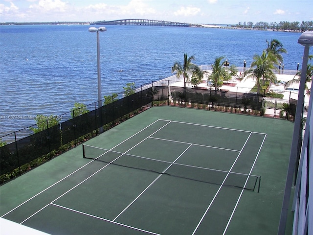 view of sport court with a water view