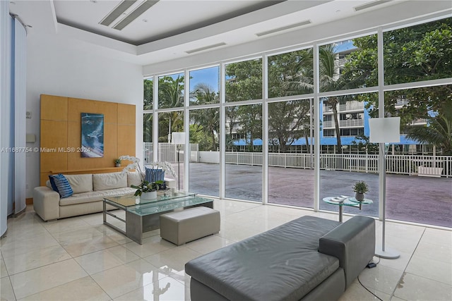 tiled living room featuring a tray ceiling