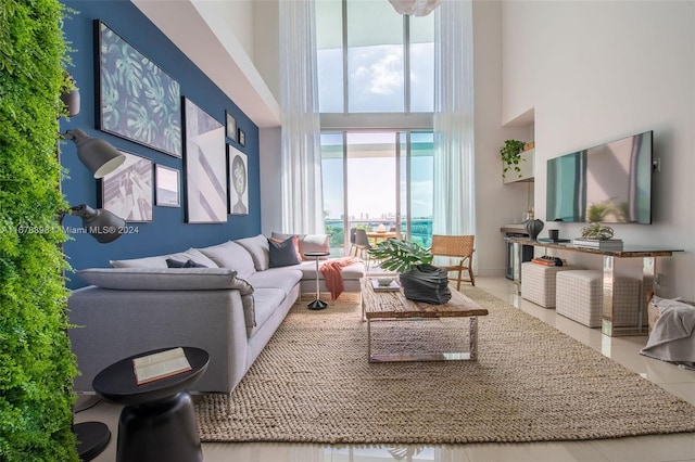 tiled living room with a high ceiling and plenty of natural light