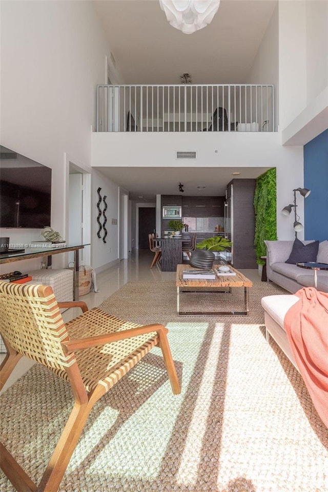 living room featuring a towering ceiling