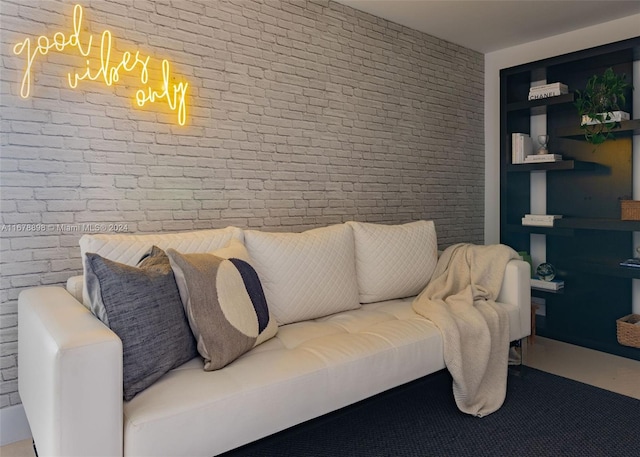 living room featuring brick wall