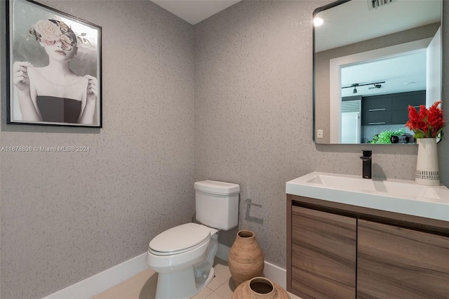 bathroom featuring vanity, toilet, and tile patterned floors