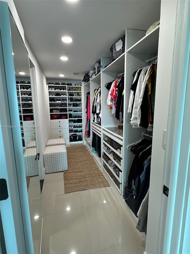 walk in closet featuring light tile patterned flooring