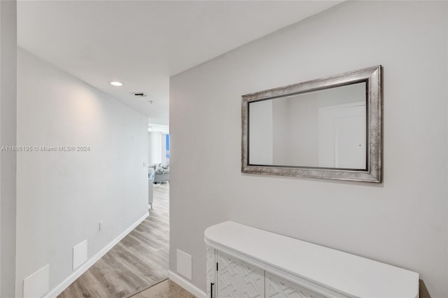 hallway with light hardwood / wood-style floors