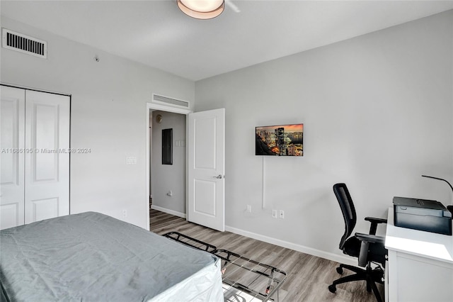 bedroom featuring a closet and light wood-type flooring