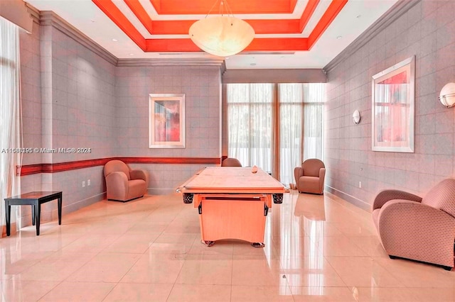 rec room featuring crown molding, a raised ceiling, and tile walls