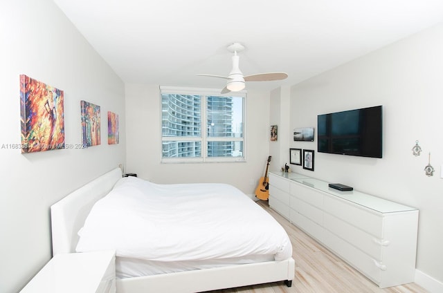 bedroom with ceiling fan and light hardwood / wood-style floors