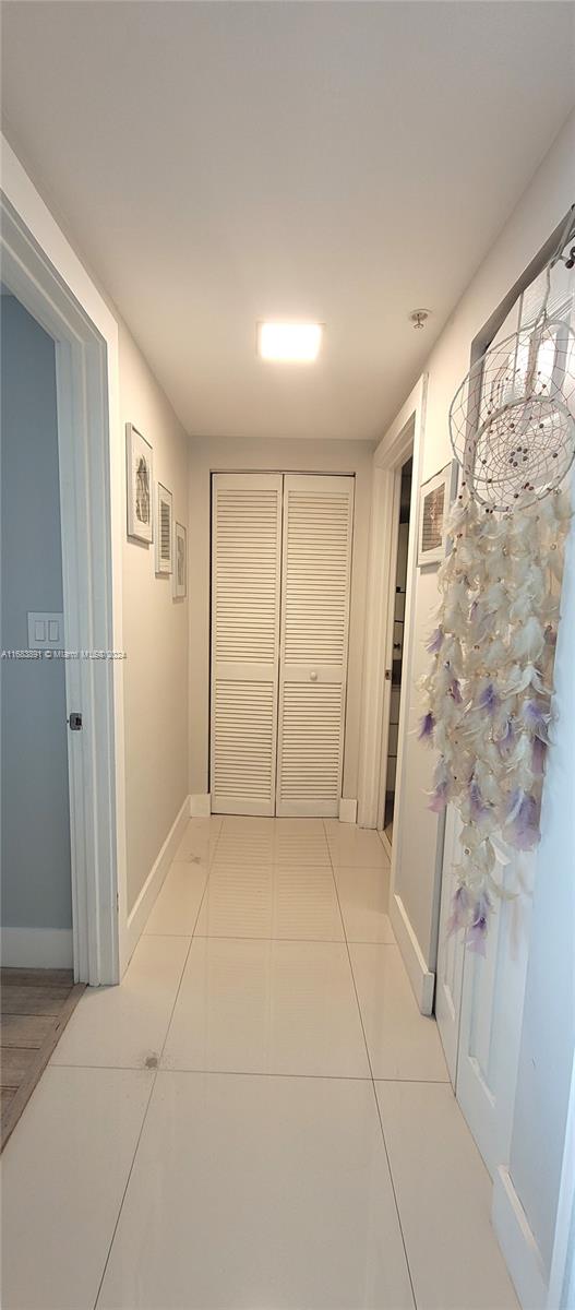 corridor featuring light tile patterned flooring