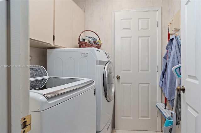 washroom featuring cabinets, washer and dryer, and tile patterned floors