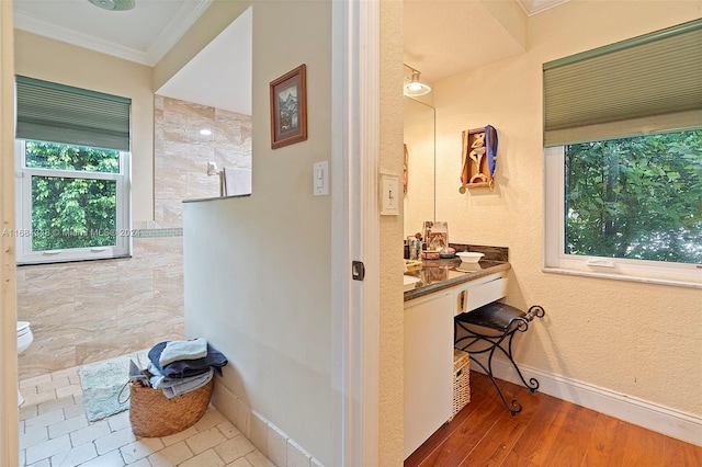 corridor featuring crown molding and light hardwood / wood-style flooring