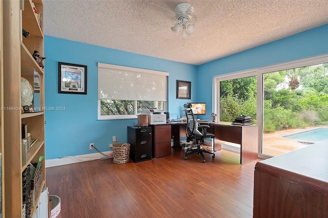 office area featuring a wealth of natural light, hardwood / wood-style floors, and a textured ceiling