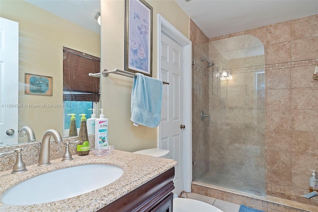 bathroom featuring vanity, a shower with shower door, and toilet