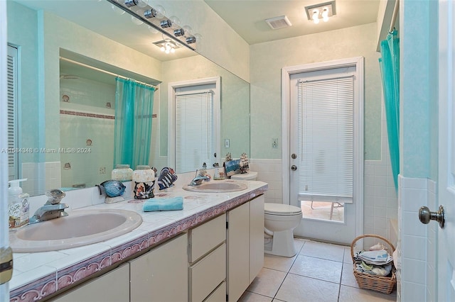 bathroom featuring vanity, a shower with shower curtain, toilet, and tile patterned floors