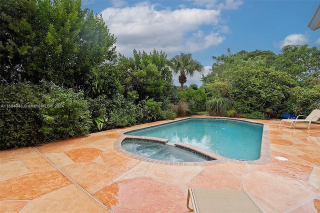 view of pool featuring a patio area and an in ground hot tub