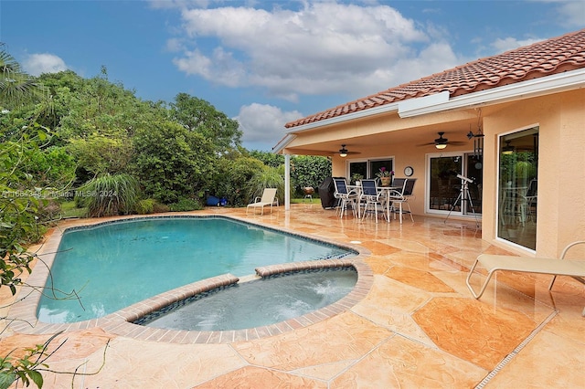 view of pool with a patio, ceiling fan, and an in ground hot tub