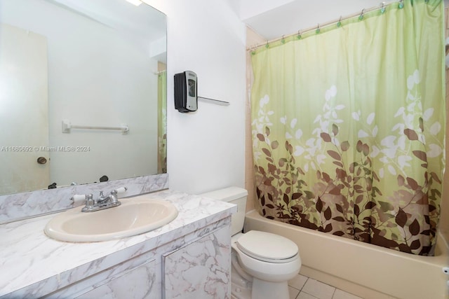 full bathroom featuring vanity, shower / bath combo with shower curtain, toilet, and tile patterned flooring