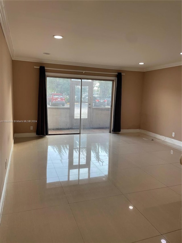 tiled spare room with ornamental molding