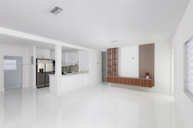 unfurnished living room with light tile patterned floors