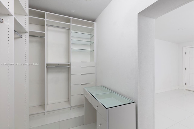 spacious closet with light tile patterned floors