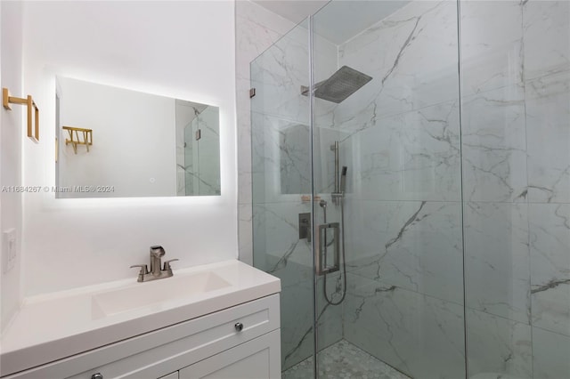 bathroom featuring vanity and an enclosed shower