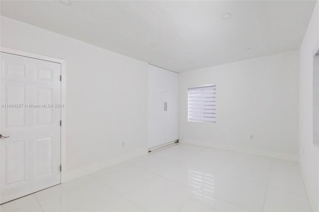 spare room featuring light tile patterned floors