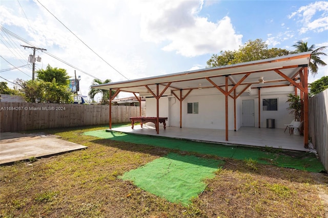 view of yard featuring ceiling fan and a patio