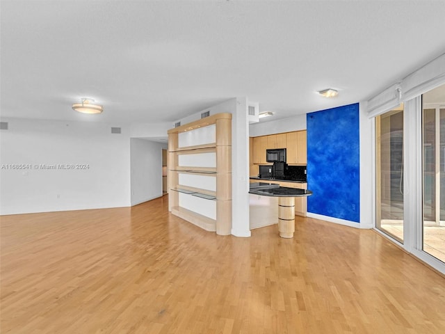 unfurnished living room with light hardwood / wood-style flooring