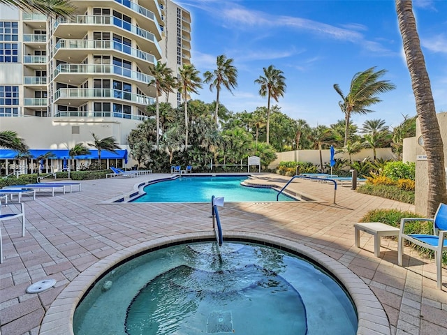 view of swimming pool with a community hot tub