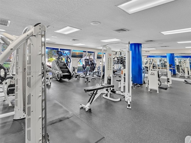 exercise room with a textured ceiling