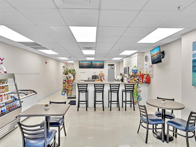 dining area featuring a paneled ceiling