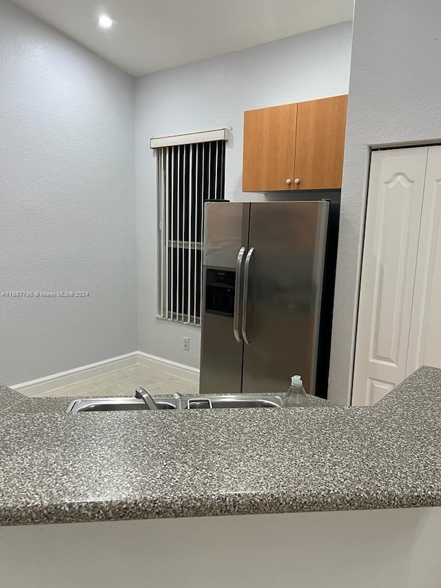 kitchen featuring stainless steel fridge with ice dispenser