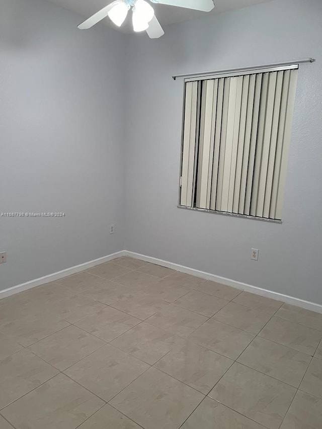 spare room featuring ceiling fan and light tile patterned floors