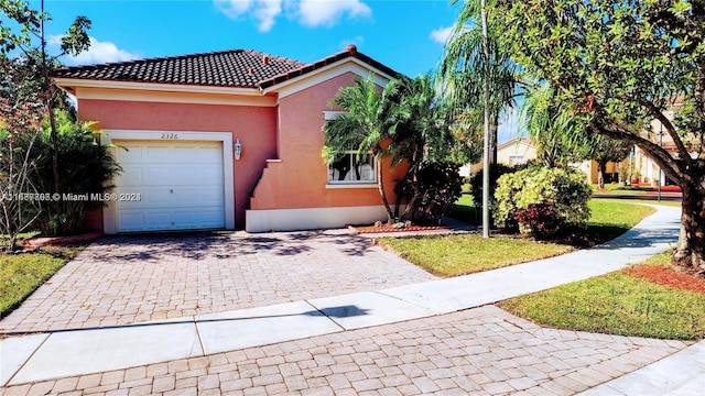 view of front of home with a garage and a front yard