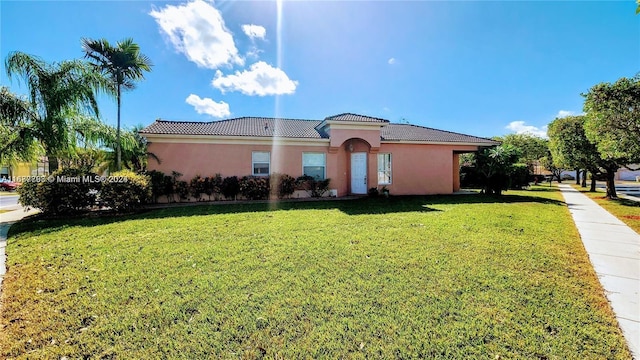 mediterranean / spanish-style house with a front yard