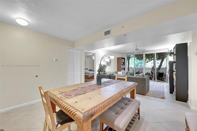 519 E Sheridan St Unit 106, Dania Beach, FL 33004 - dining area with light tile patterned floors, ceiling fan, and a textured ceiling