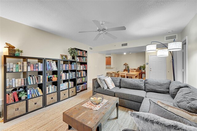 519 E Sheridan St Unit 106, Dania Beach, FL 33004 - living area featuring a textured ceiling and ceiling fan