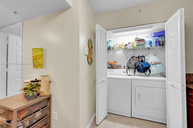 519 E Sheridan St Unit 106, Dania Beach, FL 33004 - laundry area with independent washer and dryer and light tile patterned floors
