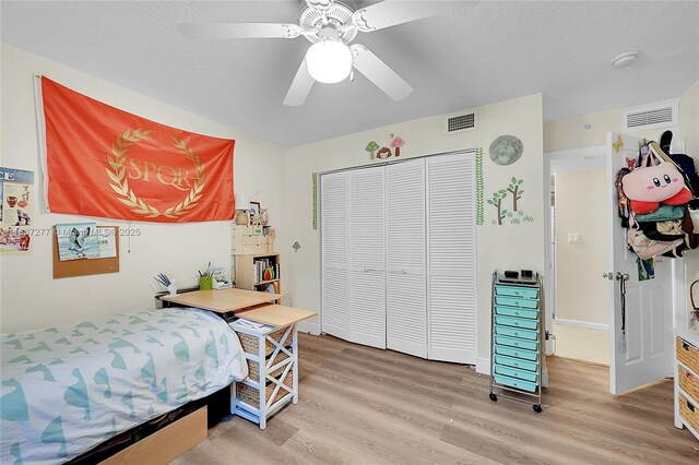 519 E Sheridan St Unit 106, Dania Beach, FL 33004 - bedroom with light wood-type flooring, a closet, a ceiling fan, and a textured ceiling