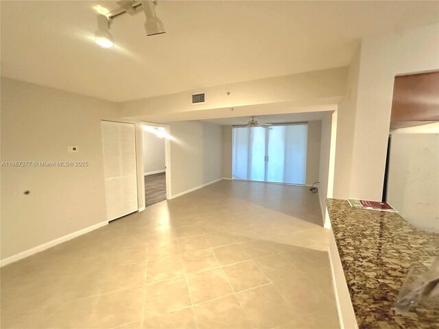 519 E Sheridan St Unit 106, Dania Beach, FL 33004 - spare room featuring light tile patterned floors, a ceiling fan, and track lighting