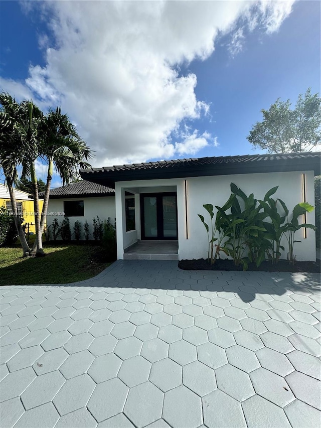 back of house with french doors and a patio